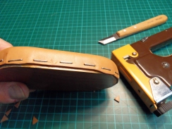 Folding the wet leather around a wooden mold and fix with a staple gun Folding the wet leather around a wooden mold and fix with a staple gun