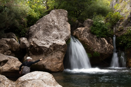 Fishing under a small waterfall Fishing under a small waterfall