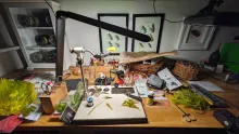 Fly tying vise and materials on a table